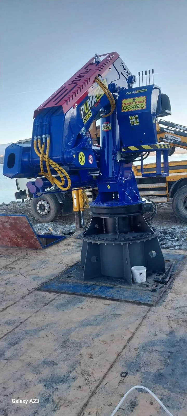Compact blue marine crane installed on a vessel deck