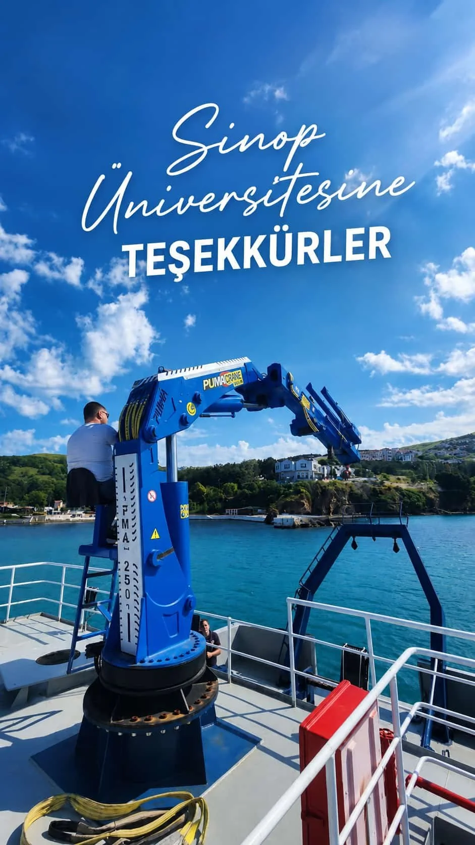 Blue knuckle-boom marine crane installed beside vessel deck equipment