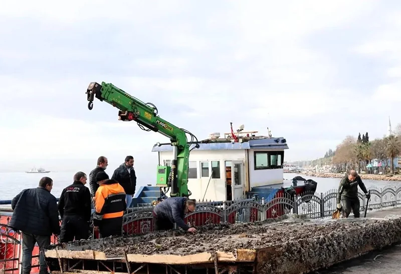 Green marine crane installed on a workboat deck
