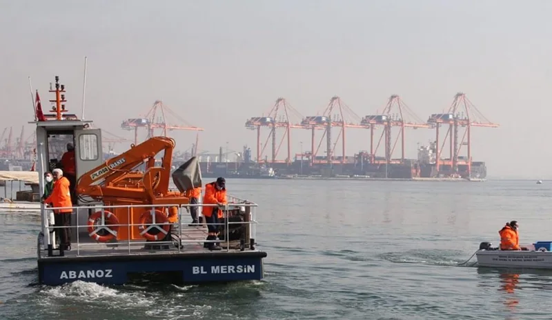 Orange marine crane installed on a workboat deck